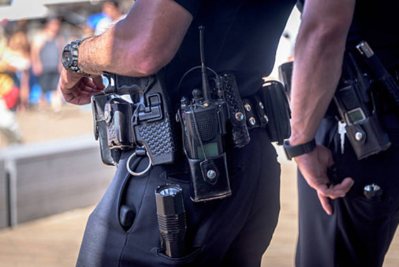 zoomed in image of two armed security guards and their equipment belts