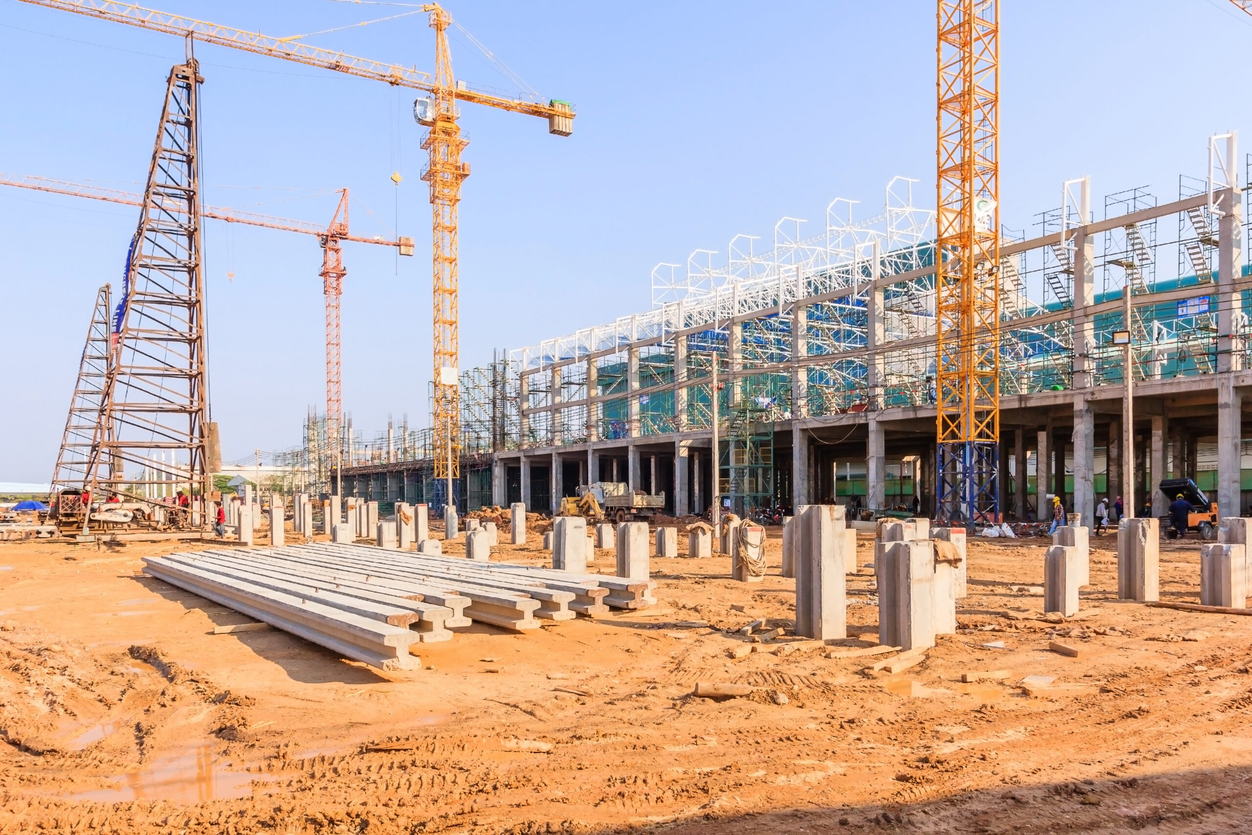 Industrial construction cranes and building in a beautiful blue sky background