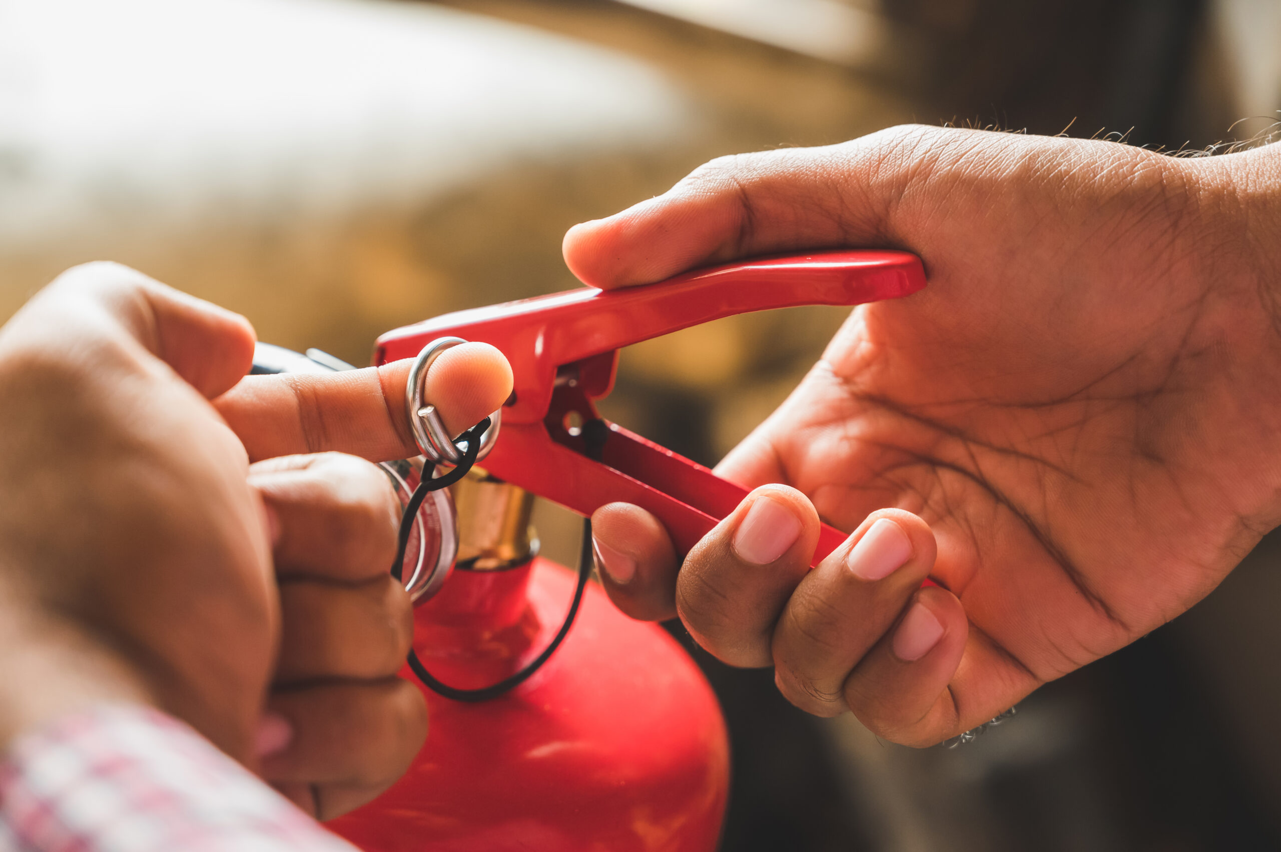 Close up hand Fireman using fire extinguisher fighting. Hand pul