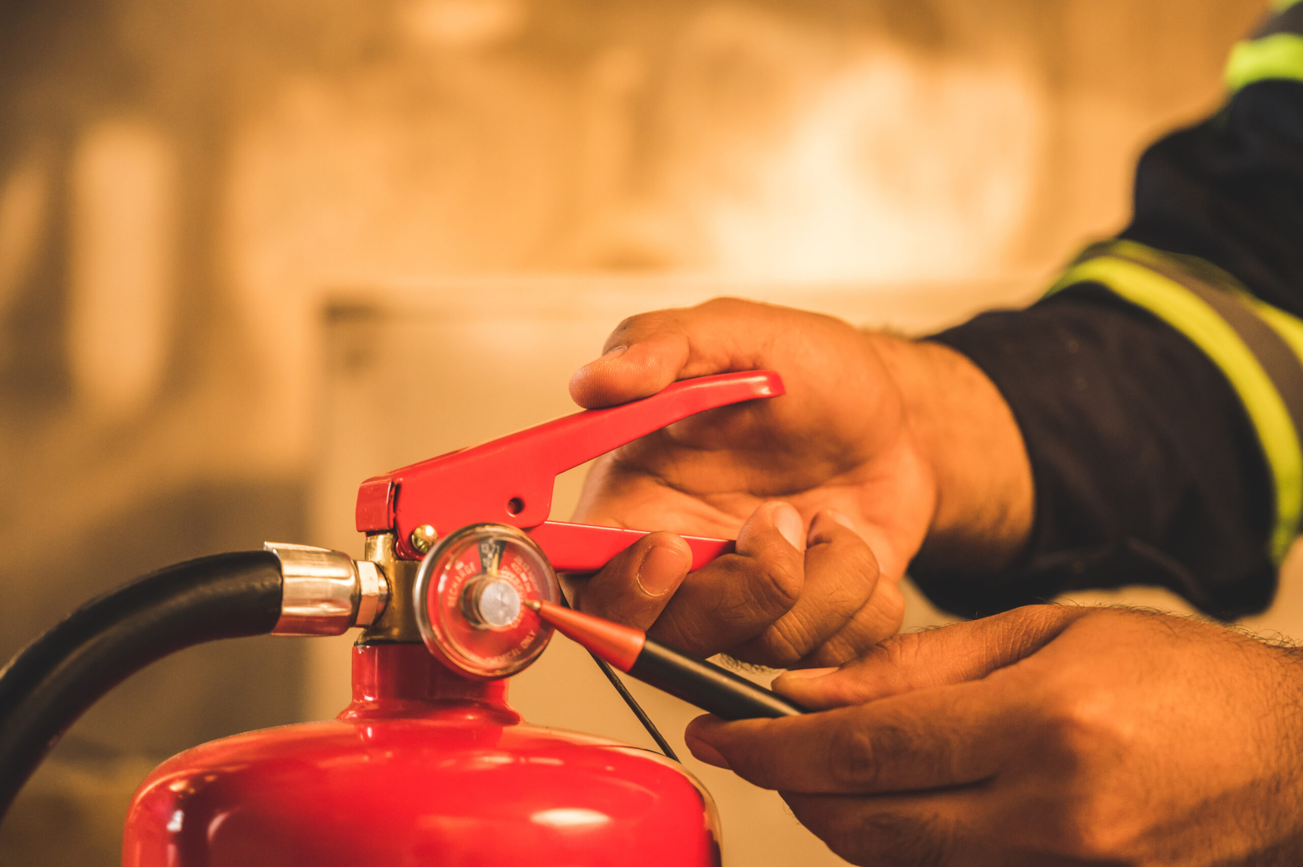 Close up hand Fireman,Firefighter checking the fire extinguisher