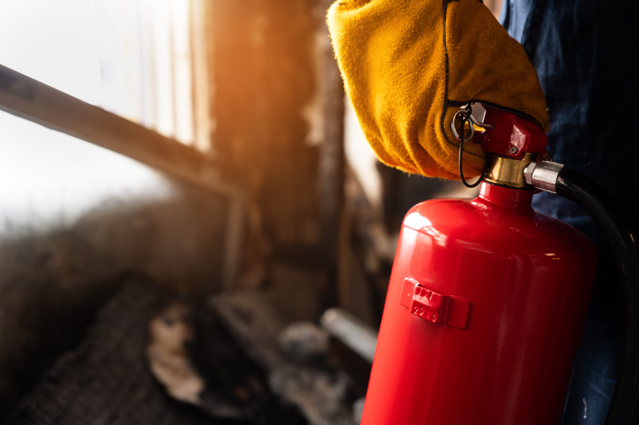 Close up hand Fireman,Firefighter holding the fire extinguisher.