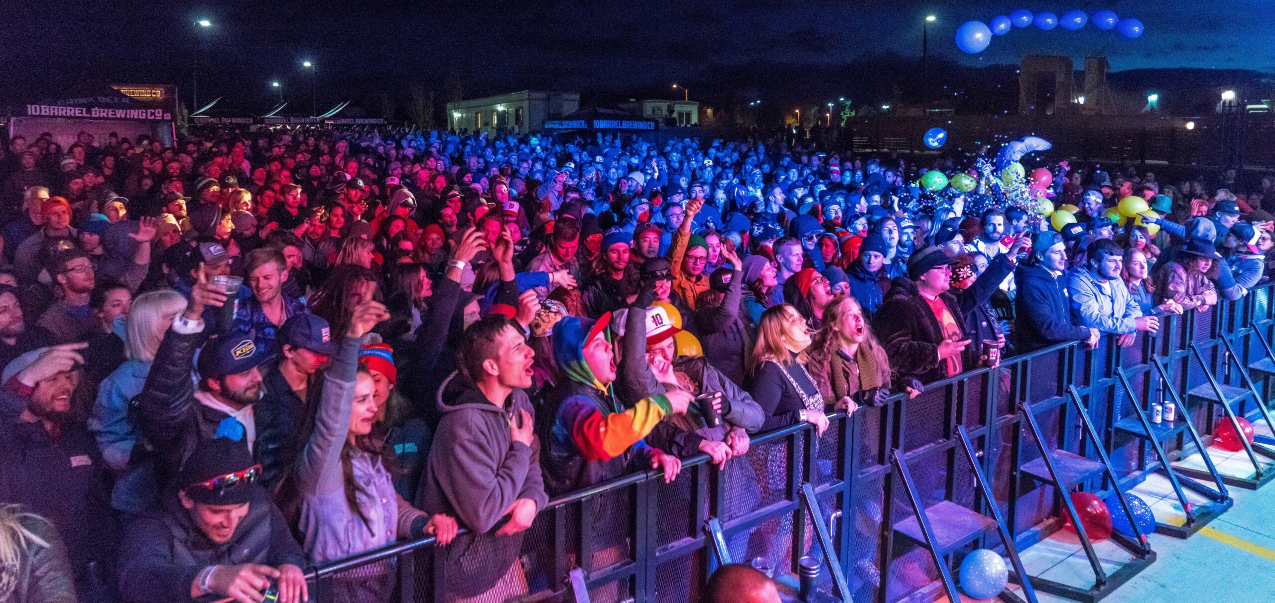 concert goers behind a security barrier