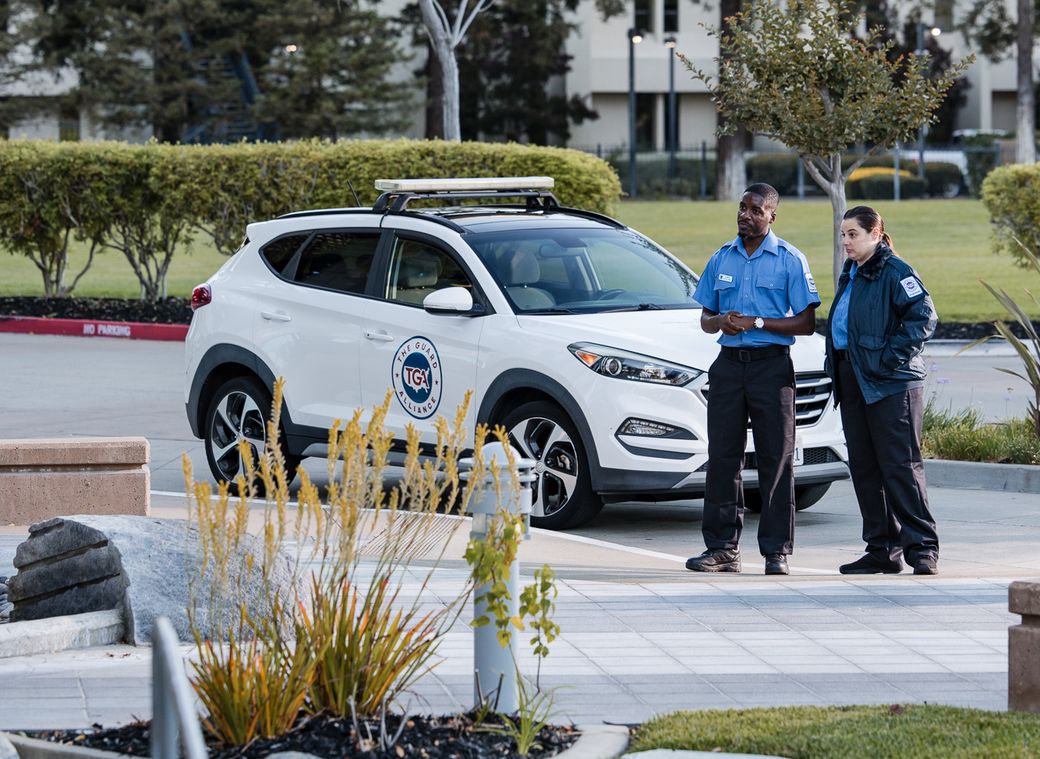 Marked TGA security patrol vehicle with two officers on a commercial campus