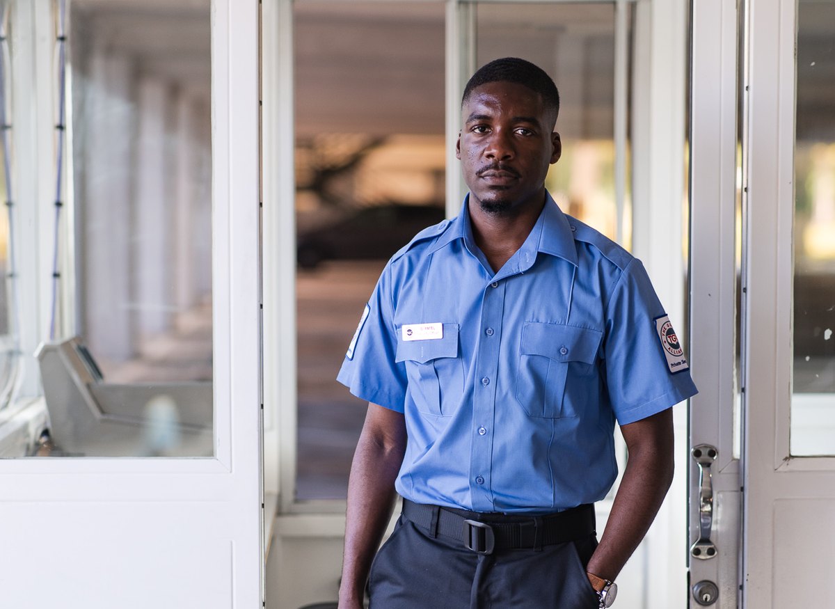Unarmed TGA security officer on post at a guard booth entrance